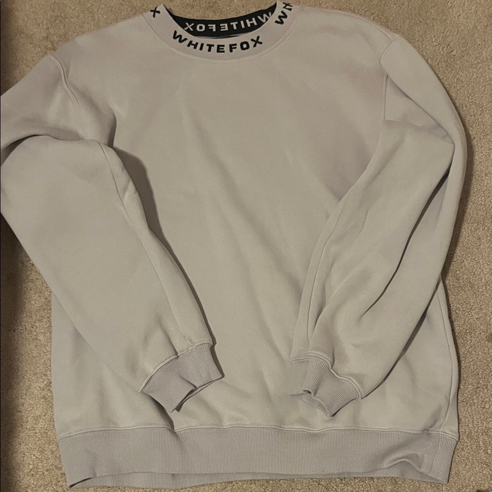 white fox mock neck sweatshirt with the neck line printed